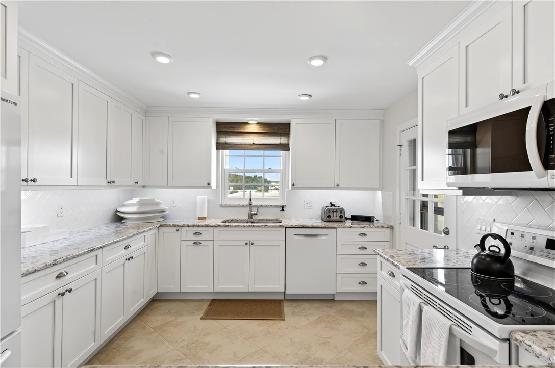 2743 Ocean Drive, Unit 50E Vero Beach, FL 32963 - Photo 4 of 36 a kitchen with stainless steel appliances granite countertop a sink stove and cabinets