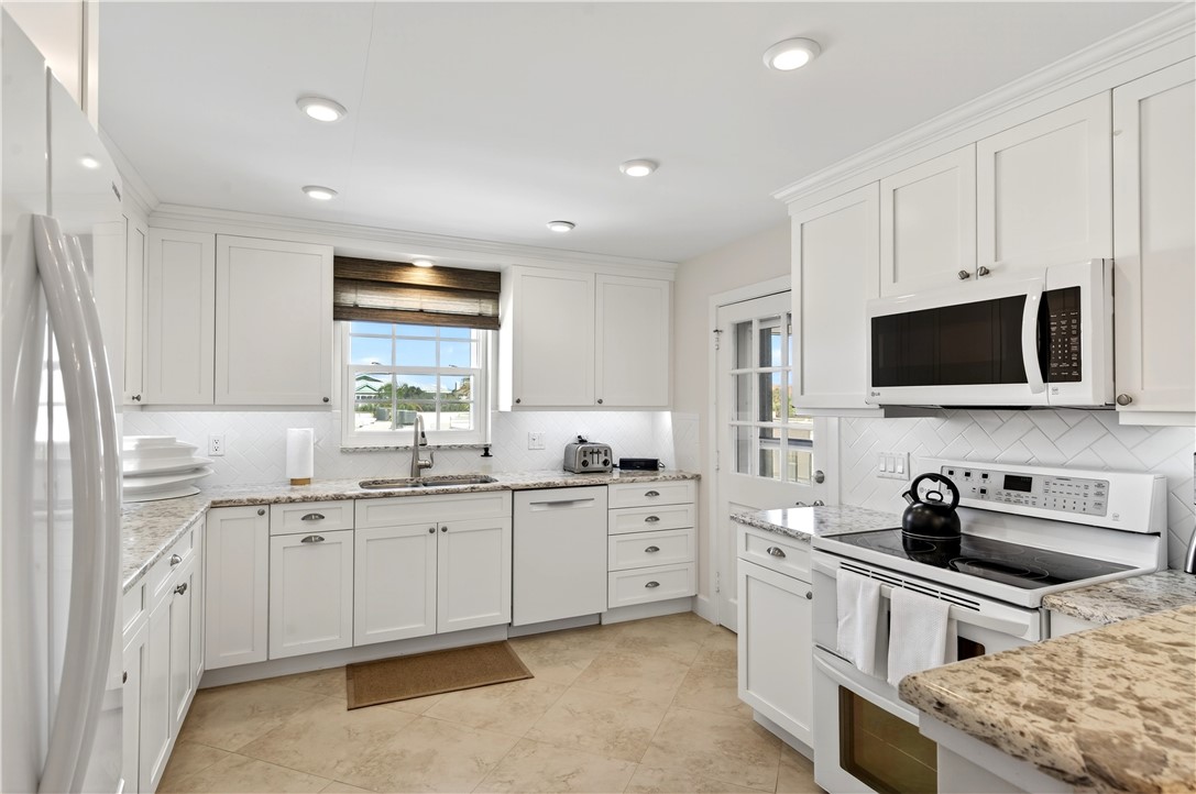 2743 Ocean Drive, Unit 50E Vero Beach, FL 32963 - Photo 7 of 36 a kitchen with a sink stove and microwave