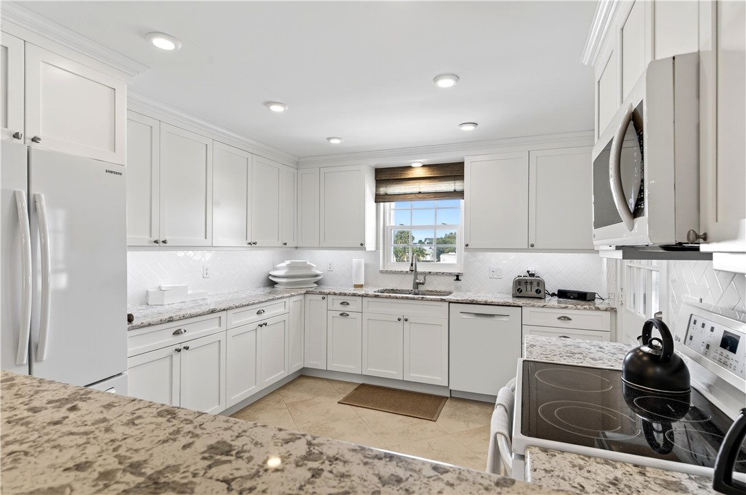 2743 Ocean Drive, Unit 50E Vero Beach, FL 32963 - Photo 8 of 36 a kitchen that has a sink and a stove in it