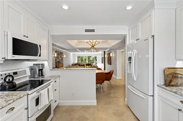 a view of a dining room with furniture and chandelier