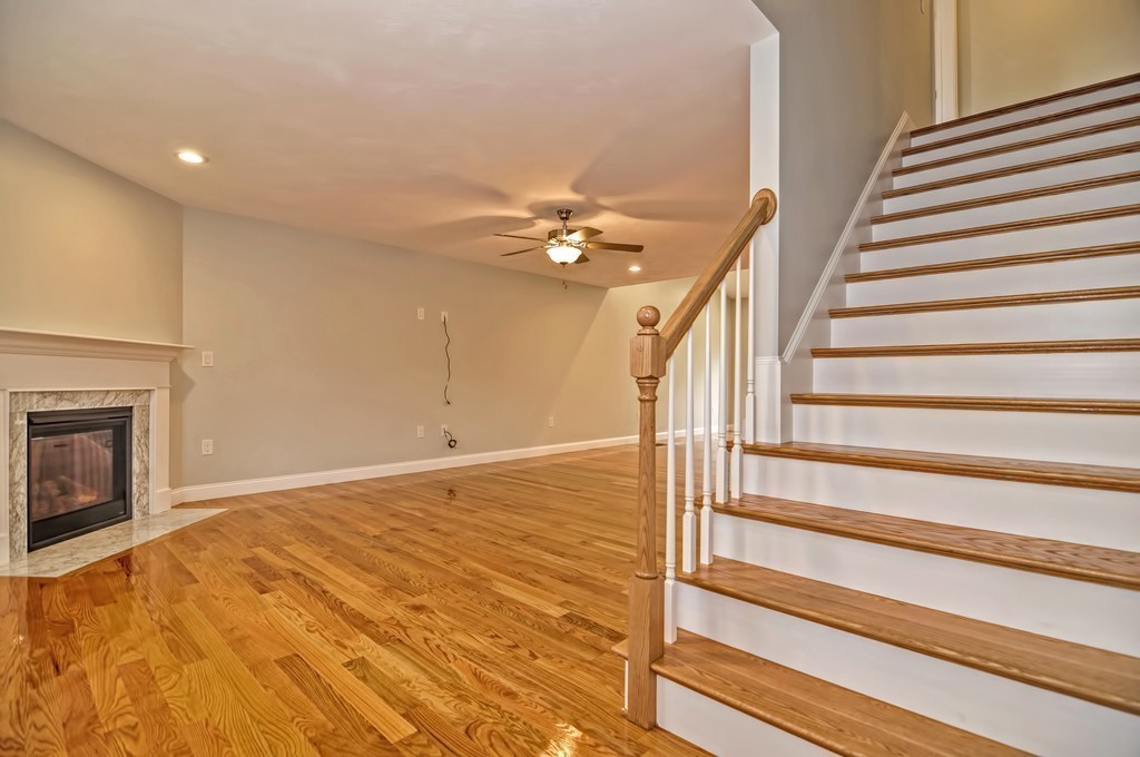 87 Ariel Circle Sutton, MA 01590 - Photo 14 of 30 a view of a livingroom with wooden floor and a ceiling fan