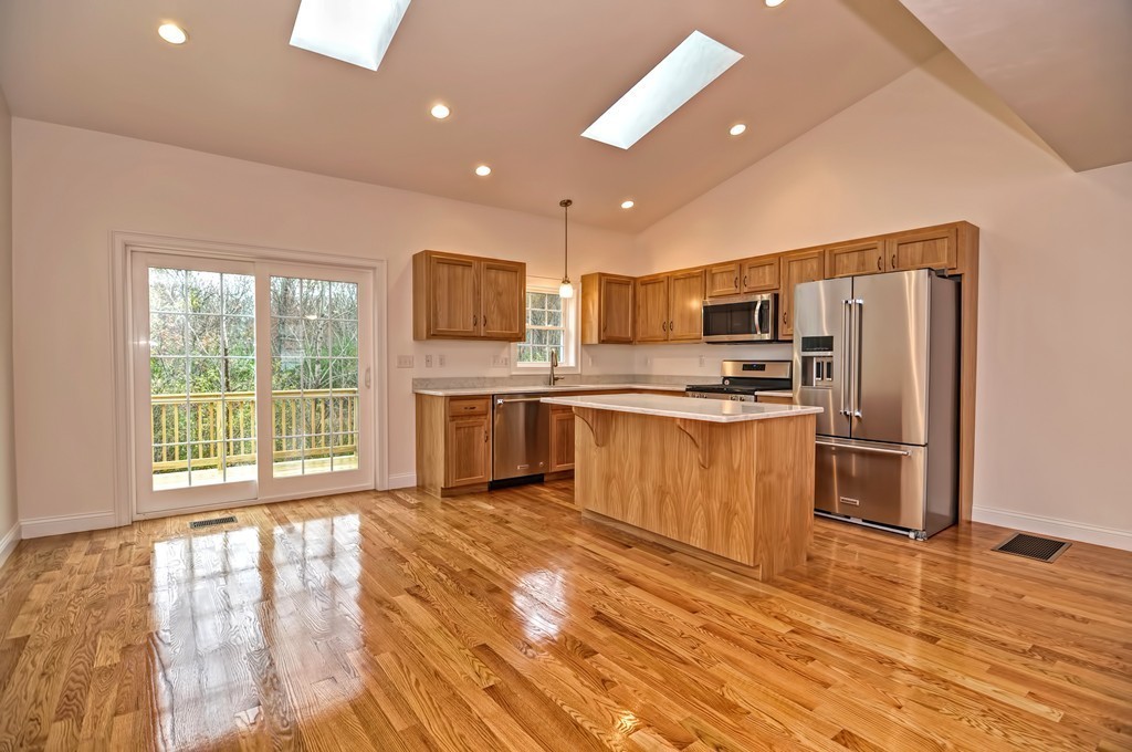 87 Ariel Circle Sutton, MA 01590 - Photo 17 of 30 a kitchen with stainless steel appliances granite countertop a refrigerator a stove top oven a sink dishwasher and a refrigerator with wooden floor