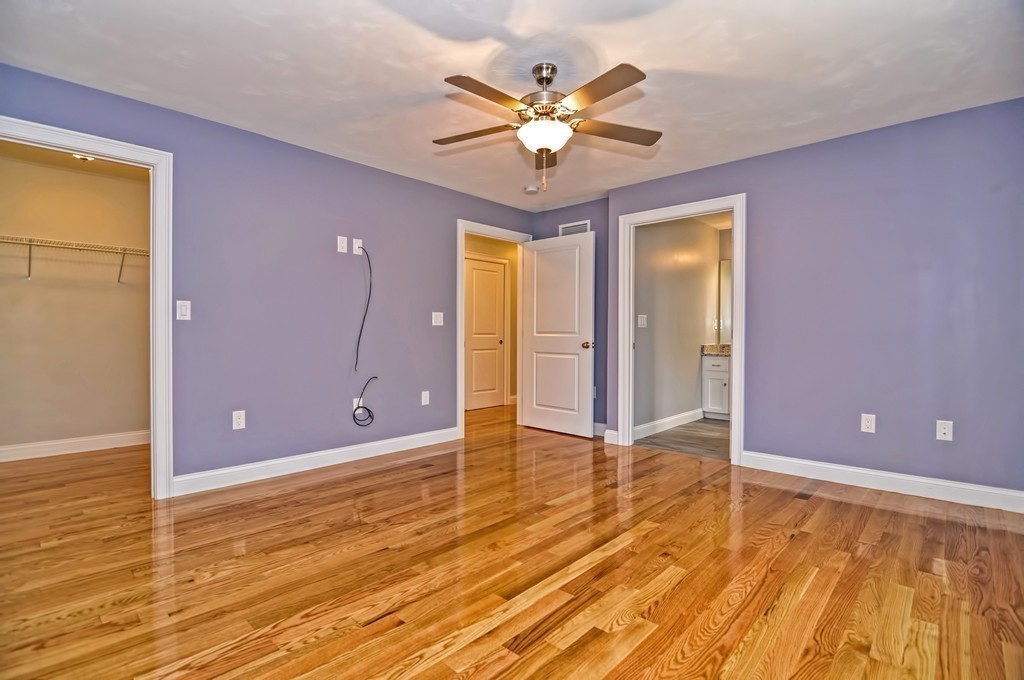 87 Ariel Circle Sutton, MA 01590 - Photo 21 of 30 a view of an empty room with chandelier fan and wooden floor