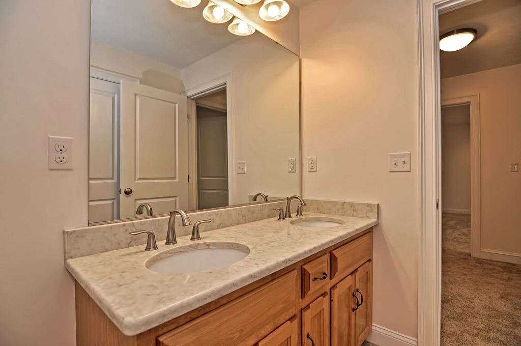 87 Ariel Circle Sutton, MA 01590 - Photo 26 of 30 a bathroom with a granite countertop sink and a mirror