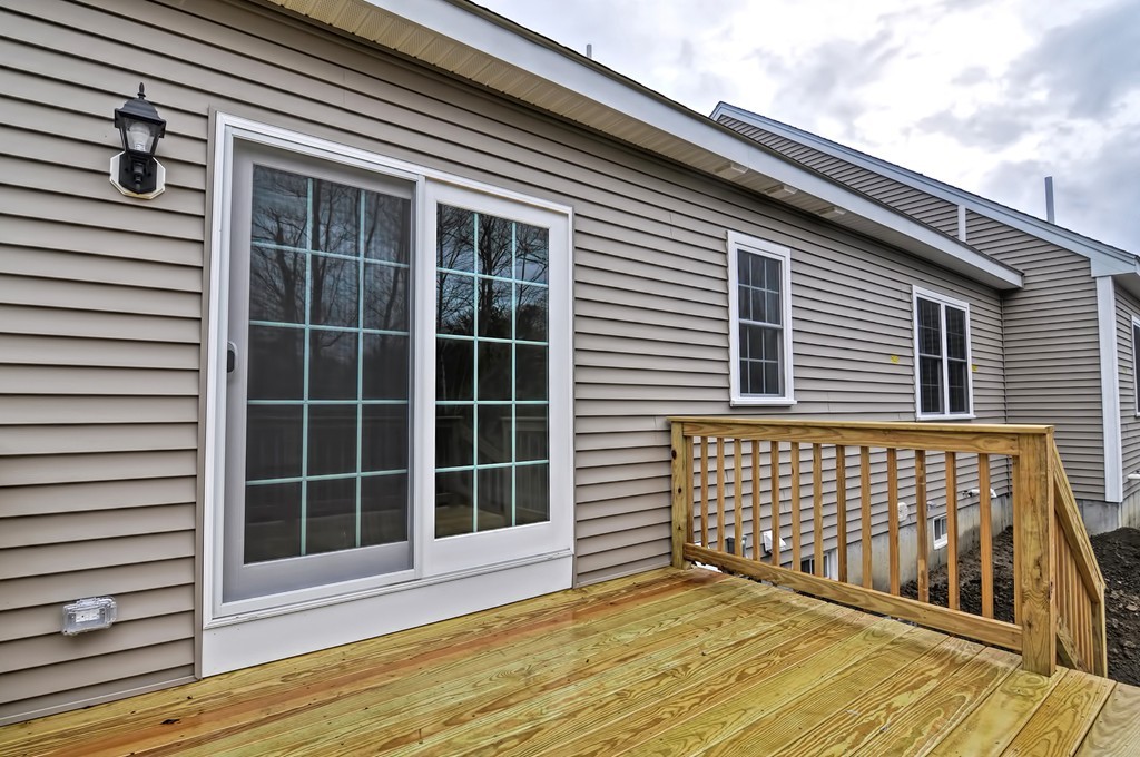 87 Ariel Circle Sutton, MA 01590 - Photo 29 of 30 a view of backyard with large windows