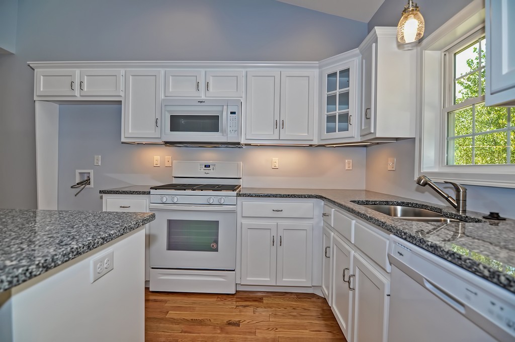 87 Ariel Circle Sutton, MA 01590 - Photo 4 of 30 a kitchen with granite countertop a sink stove and cabinets