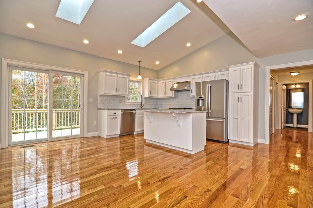 87 Ariel Circle Sutton, MA 01590 - Photo 9 of 30 a kitchen with stainless steel appliances granite countertop a refrigerator a sink dishwasher and a stove with wooden floor