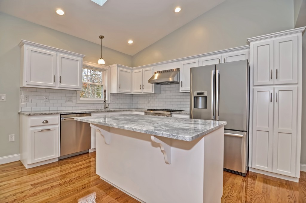 87 Ariel Circle Sutton, MA 01590 - Photo 10 of 30 a kitchen with a stove a sink and a refrigerator
