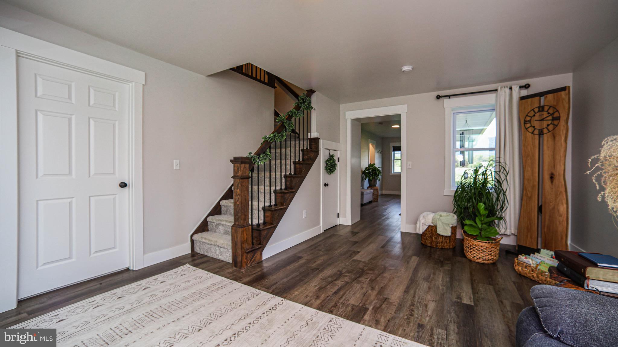 1203 Roxbury Road Newburg, PA 17240 - Photo 17 of 64 a living room with wooden floor and stairs