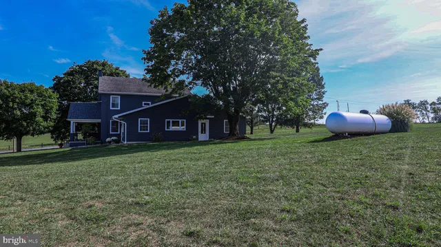 a view of a house with a yard balcony and furniture