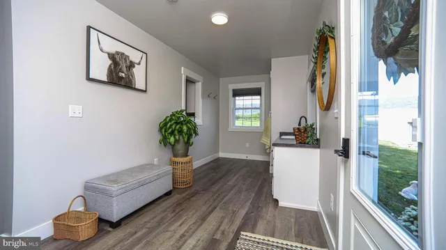 a kitchen with stainless steel appliances granite countertop a refrigerator dining table and chairs