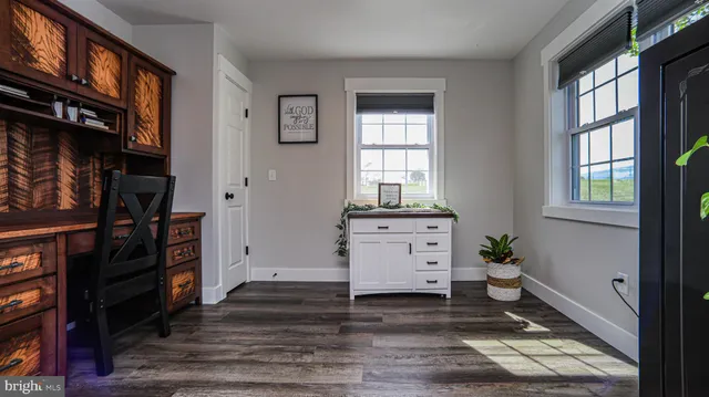 a bedroom with a bed and a ceiling fan