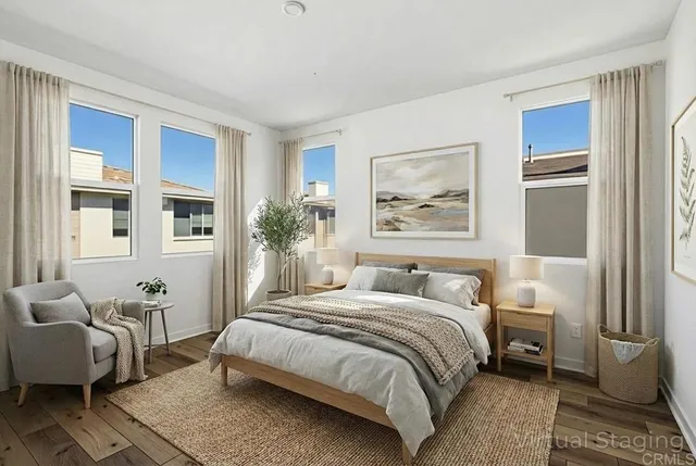 a bedroom with a large bed couch and a window