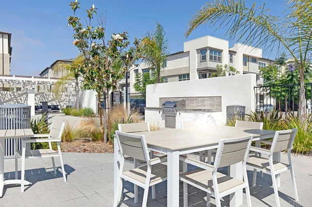 a view of a patio with table and chairs and potted plants