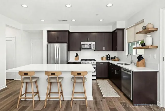 a kitchen with a sink a stove a refrigerator and cabinets