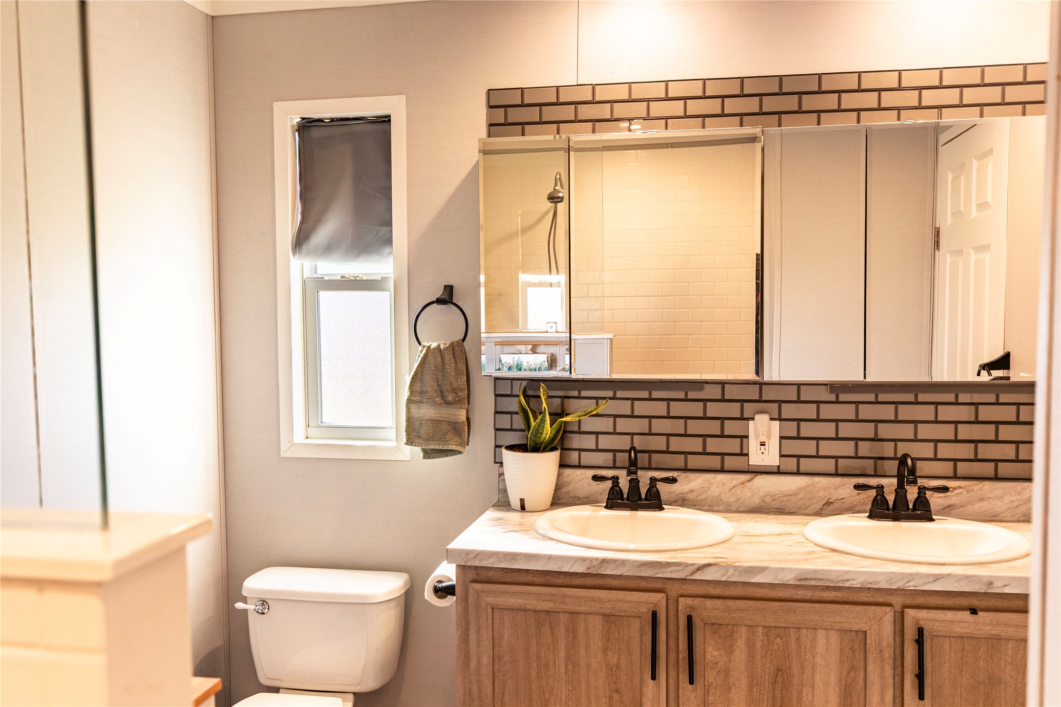 2752 Remmert Road Bellville, TX 77418 - Photo 12 of 19 This master bath features a modern design with dual sinks and large mirror with a brick-style backsplash.