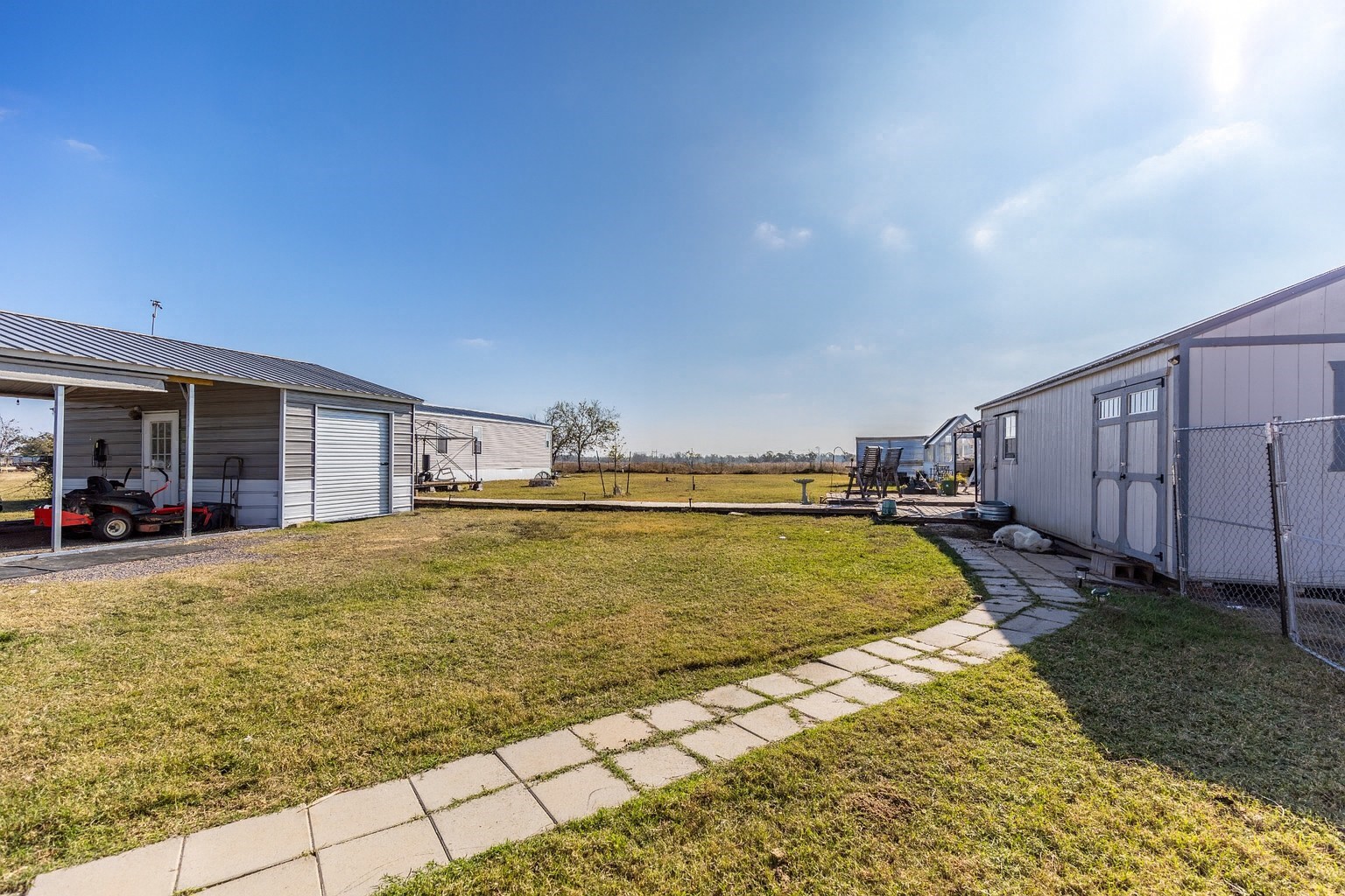 2752 Remmert Road Bellville, TX 77418 - Photo 15 of 19 More expansive outdoor space lies between the workshop, the carport and the home.