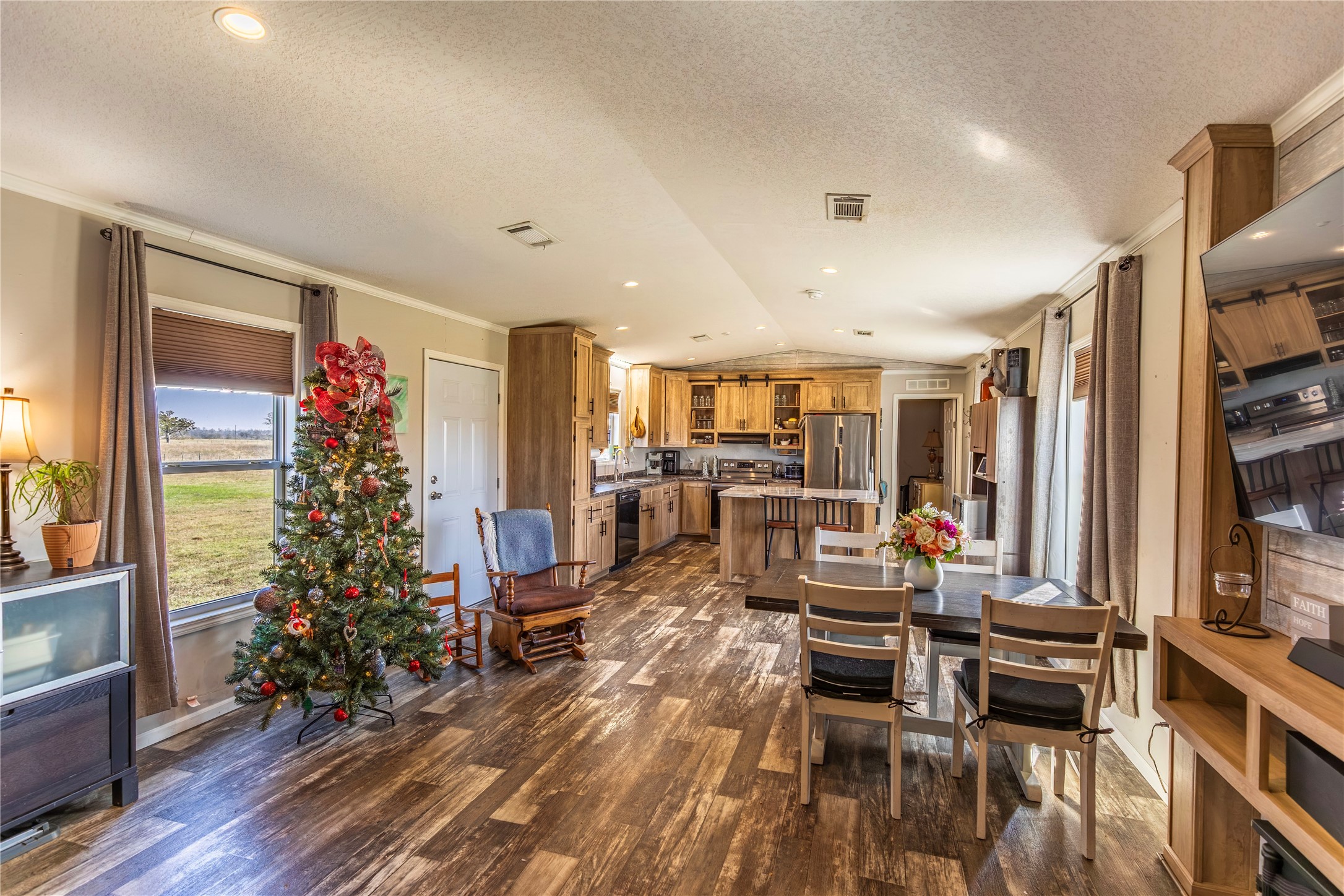 2752 Remmert Road Bellville, TX 77418 - Photo 6 of 19 Warm, wood-look, open-concept living area features ample natural light from large windows.