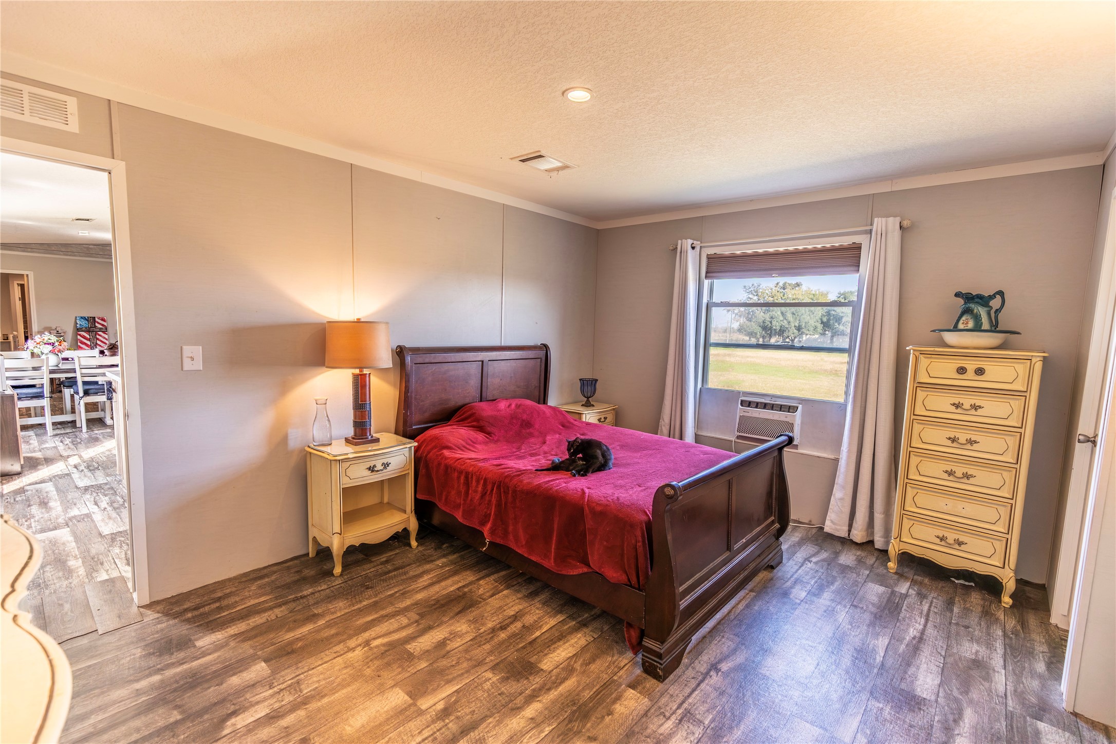 2752 Remmert Road Bellville, TX 77418 - Photo 10 of 19 Another view of the cozy master bedroom, featuring the warm wood-look flooring.