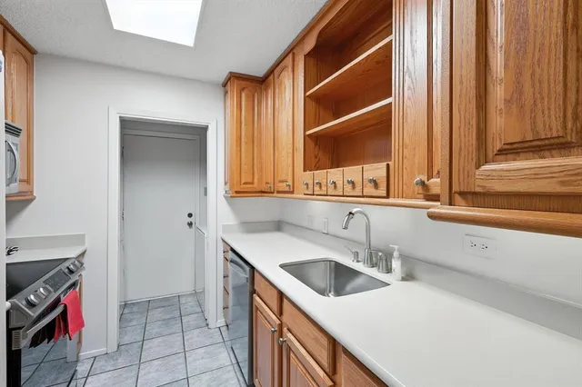 a kitchen with stainless steel appliances granite countertop a stove and a microwave