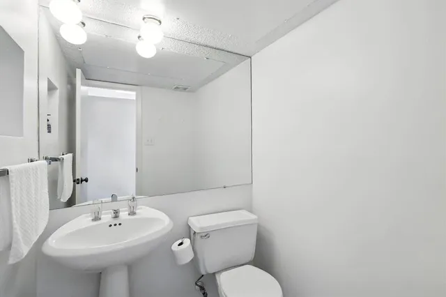 a view of a room with a ceiling fan and a window