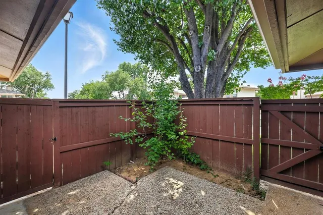 a backyard of a house with table and chairs