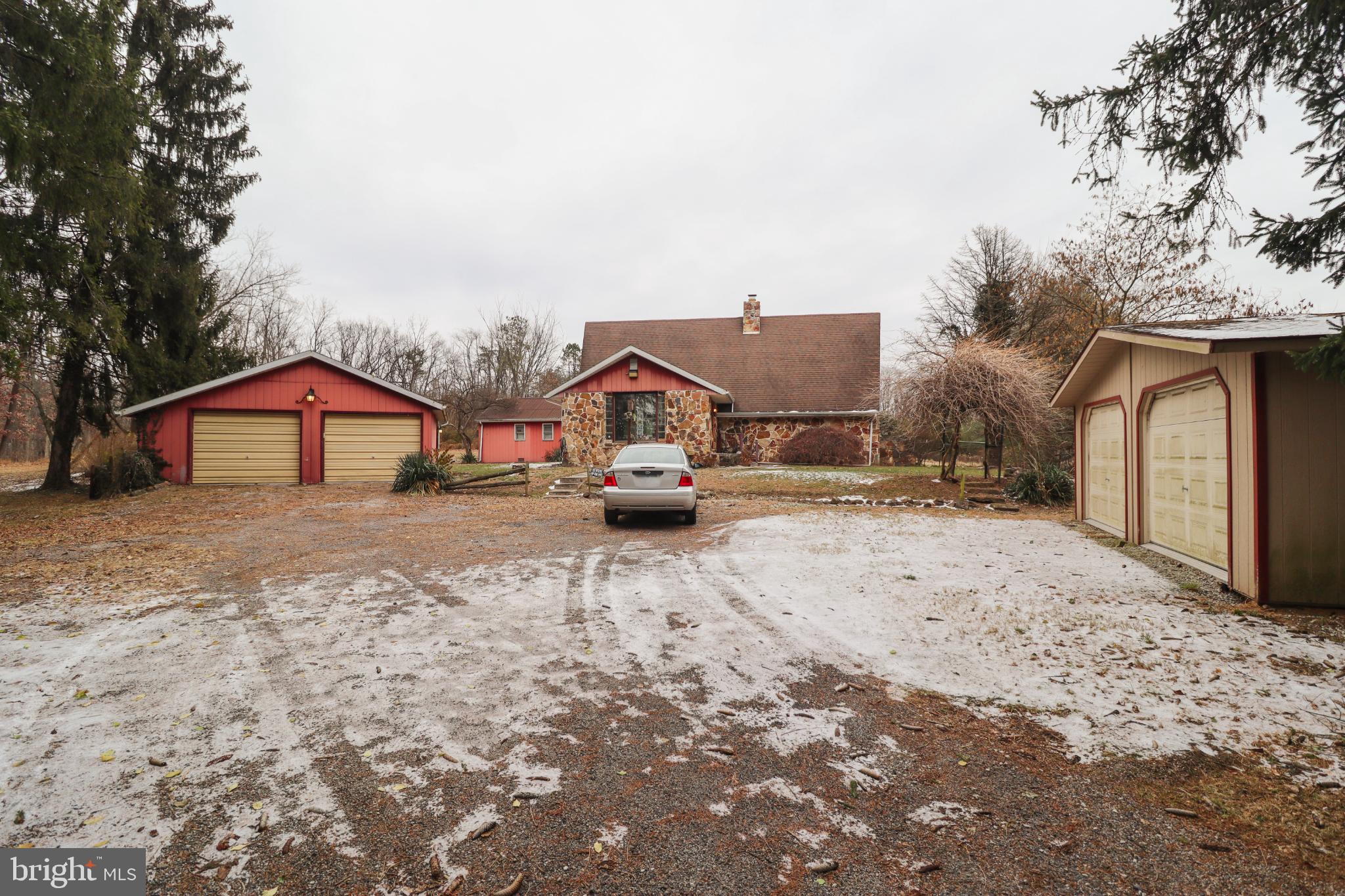 a yellow and red house with a snow on the side of the road