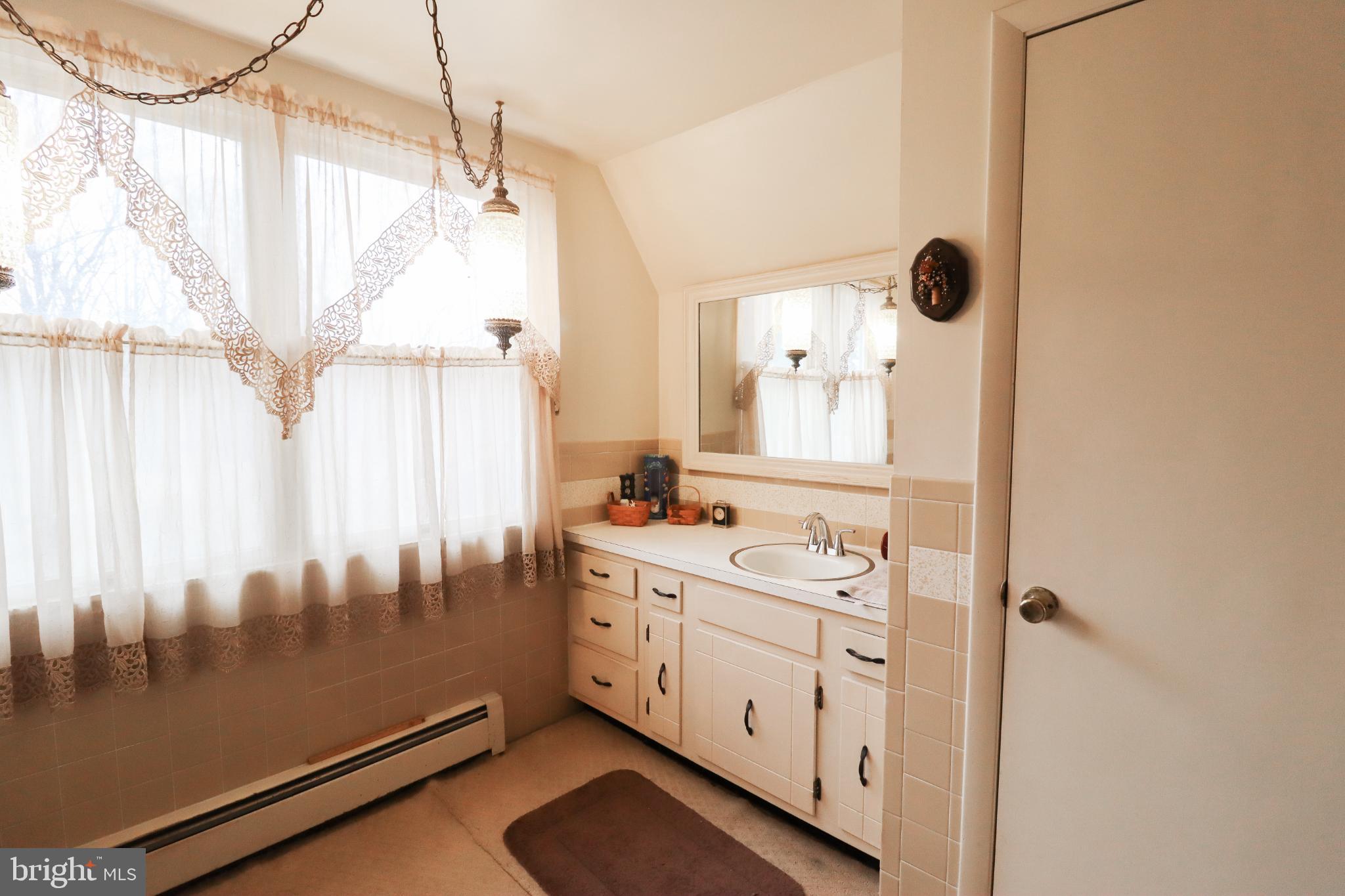 81 Rupp Road Gettysburg, PA 17325 - Photo 22 of 53 a view of a bathroom with a sink and a mirror
