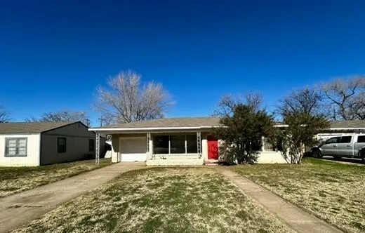a view of a house with a yard and garage