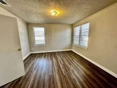 a view of an empty room and wooden floor