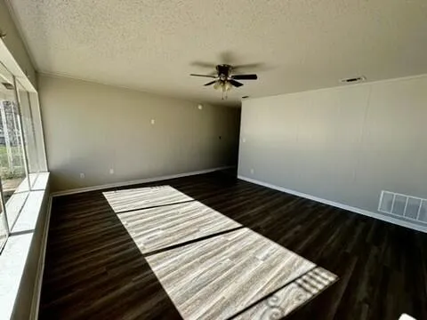 a view of a livingroom with a ceiling fan and window
