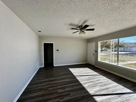 a view of a room with wooden floor and windows