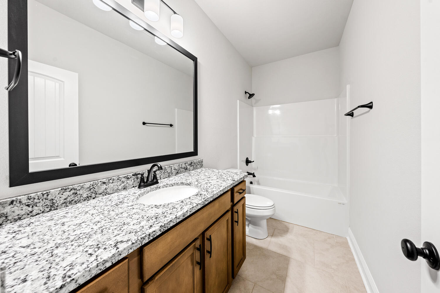 130 Hydrangea Boulevard Freeport, FL 32439 - Photo 18 of 21 a bathroom with a granite countertop sink and a mirror