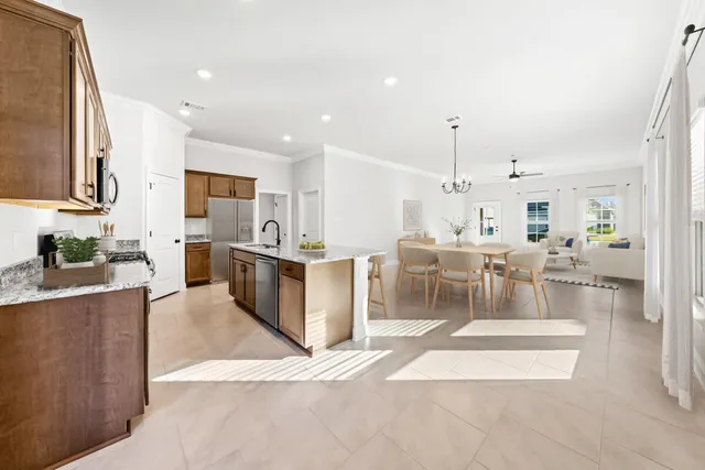 a large kitchen with a table and chairs