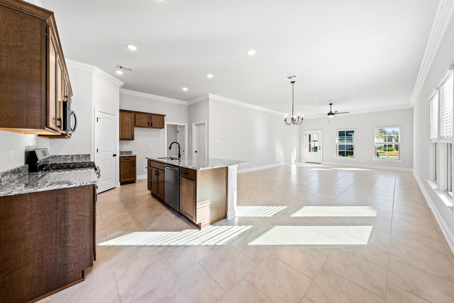 130 Hydrangea Boulevard Freeport, FL 32439 - Photo 3 of 21 a large kitchen with stainless steel appliances kitchen island a large counter top and a view of living room