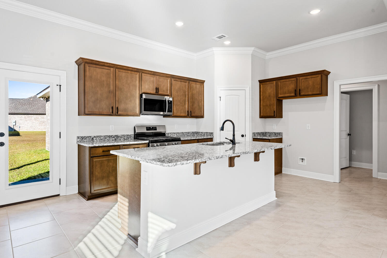 130 Hydrangea Boulevard Freeport, FL 32439 - Photo 6 of 21 a kitchen with stainless steel appliances a stove top oven a sink a refrigerator and a microwave