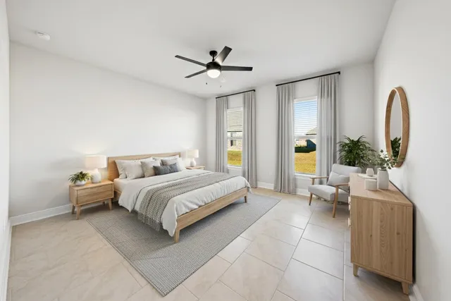 a spacious bedroom with a bed and a chandelier