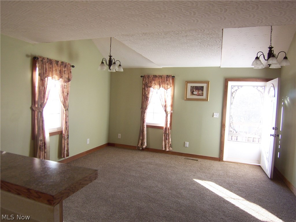 29 Fall Run Road Walker, WV 26180 - Photo 12 of 35 Living room...brand new carpet...front door leading out to the wrap around porch