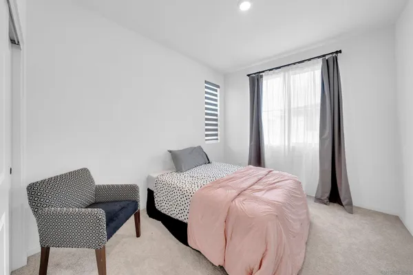 a bedroom with a bed and a chair