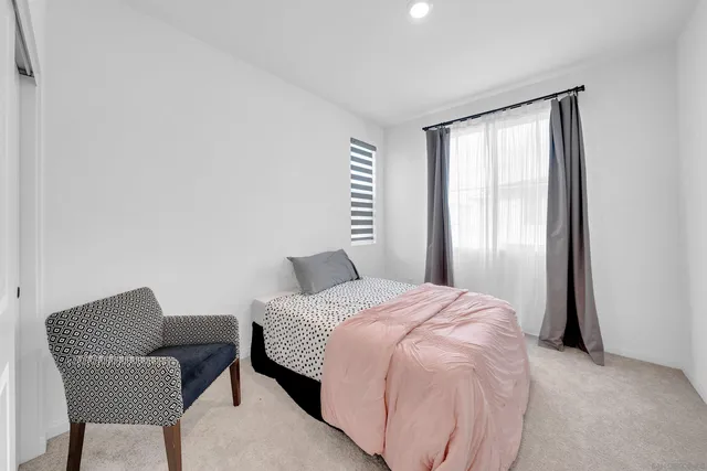 a bedroom with a bed and a chair