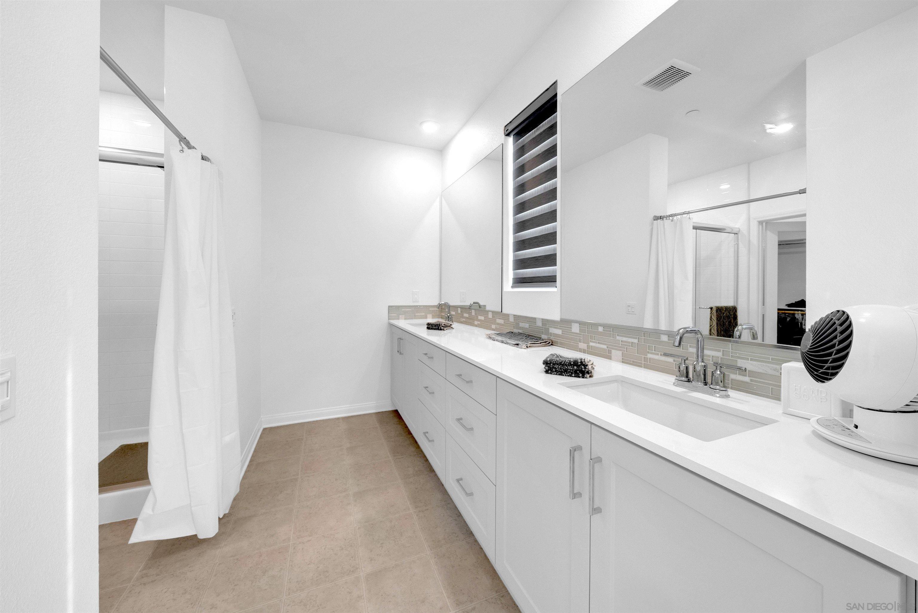 2027 Bluestone Circle Chula Vista, CA 91913 - Photo 24 of 29 a bathroom with a double vanity sink and mirror