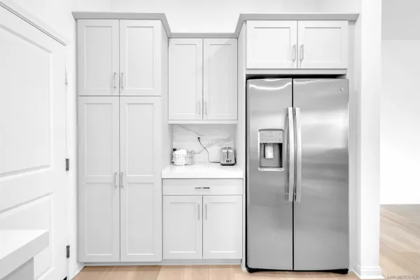 a kitchen with cabinets and a refrigerator