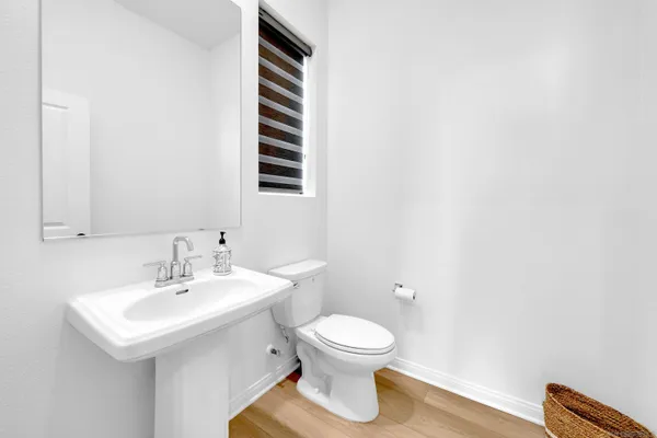 a bathroom with a sink a toilet and a mirror