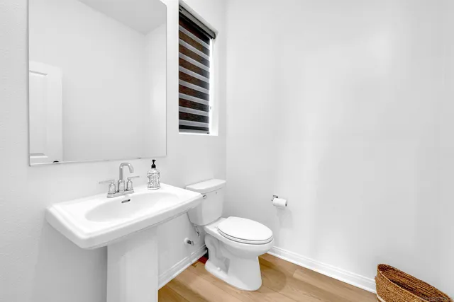 a bathroom with a sink a toilet and a mirror