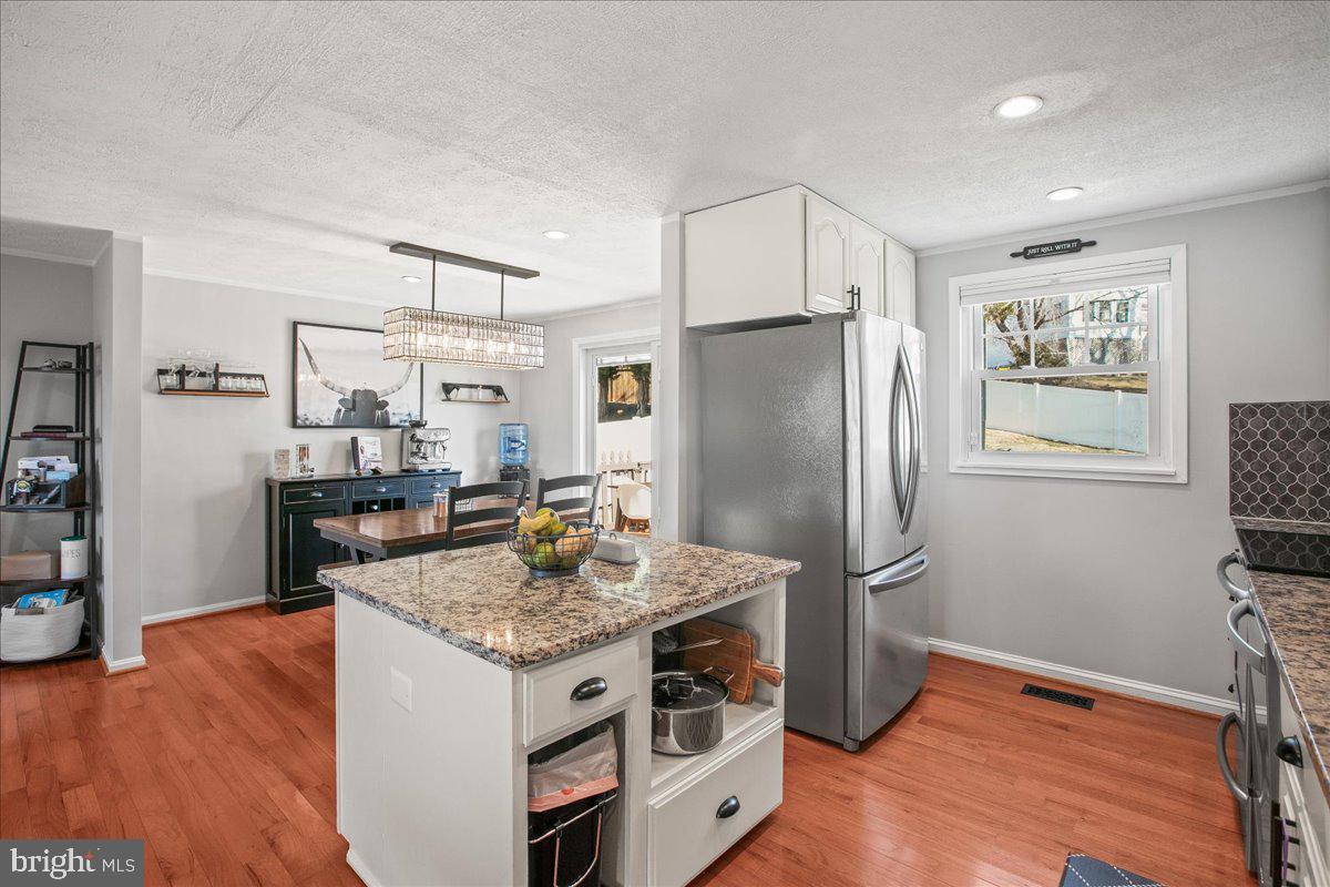 5829 Parakeet Drive Burke, VA 22015 - Photo 11 of 27 a kitchen with stainless steel appliances granite countertop a refrigerator and a stove top oven
