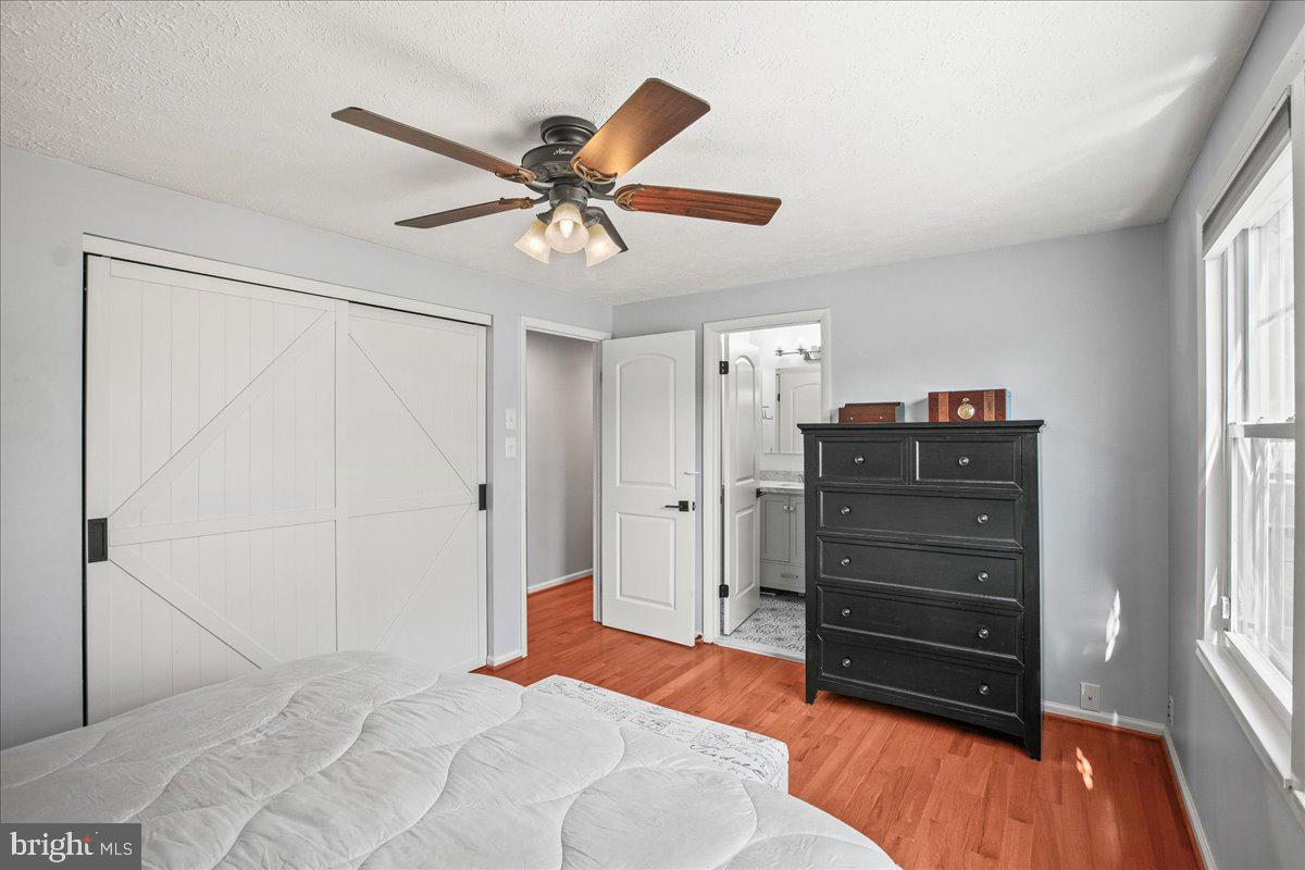 5829 Parakeet Drive Burke, VA 22015 - Photo 20 of 27 a bedroom with a dresser and a chandelier
