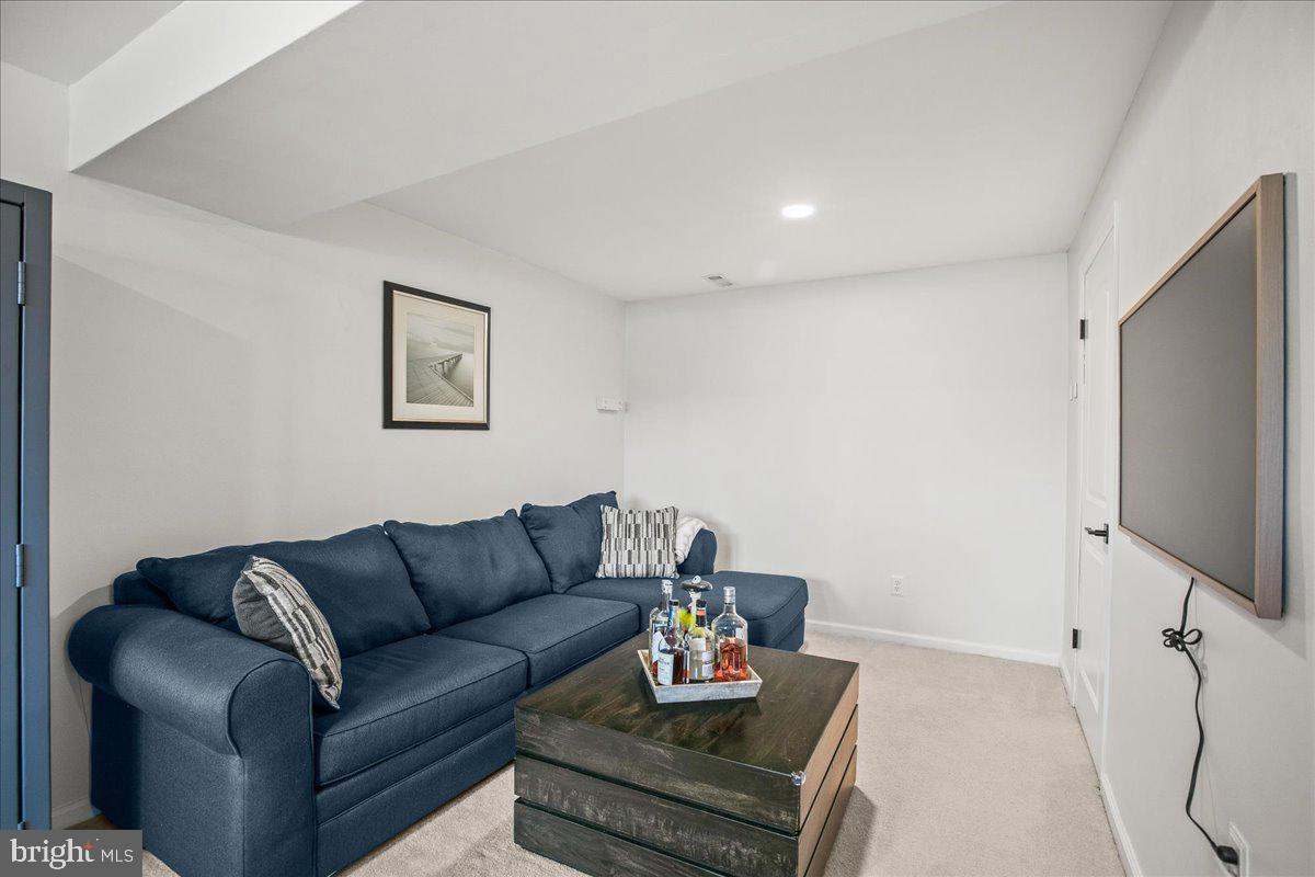 5829 Parakeet Drive Burke, VA 22015 - Photo 21 of 27 a living room with furniture and a flat screen tv