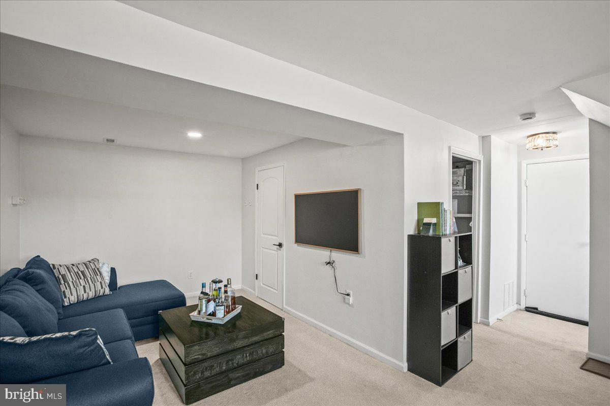 5829 Parakeet Drive Burke, VA 22015 - Photo 22 of 27 a living room with furniture and a flat screen tv