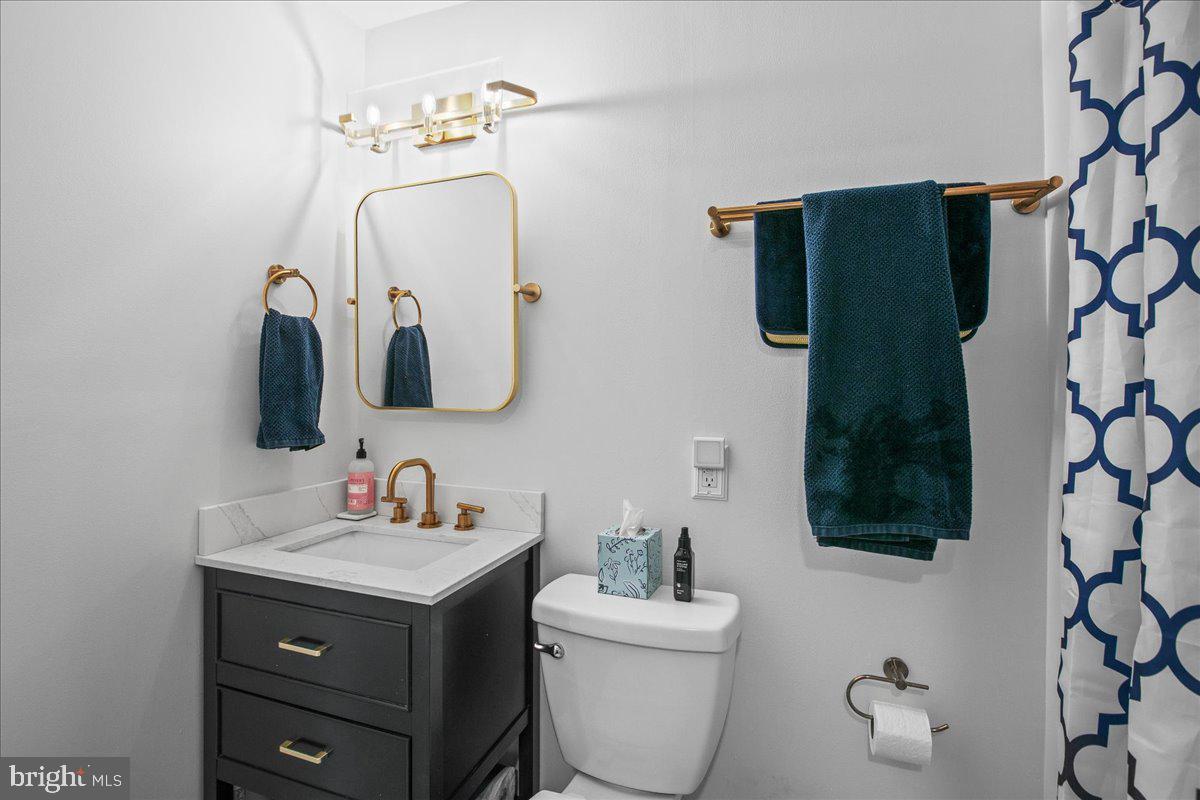 5829 Parakeet Drive Burke, VA 22015 - Photo 24 of 27 a bathroom with a toilet sink and mirror