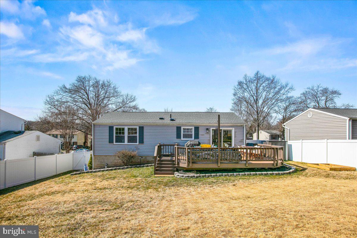 5829 Parakeet Drive Burke, VA 22015 - Photo 25 of 27 a front view of a house with a yard covered with snow and trees